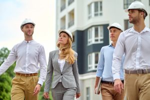 Checking woman and group of workers looking to side